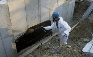 Professional waterproofing the exterior walls of the basement in Santa Ana, CA